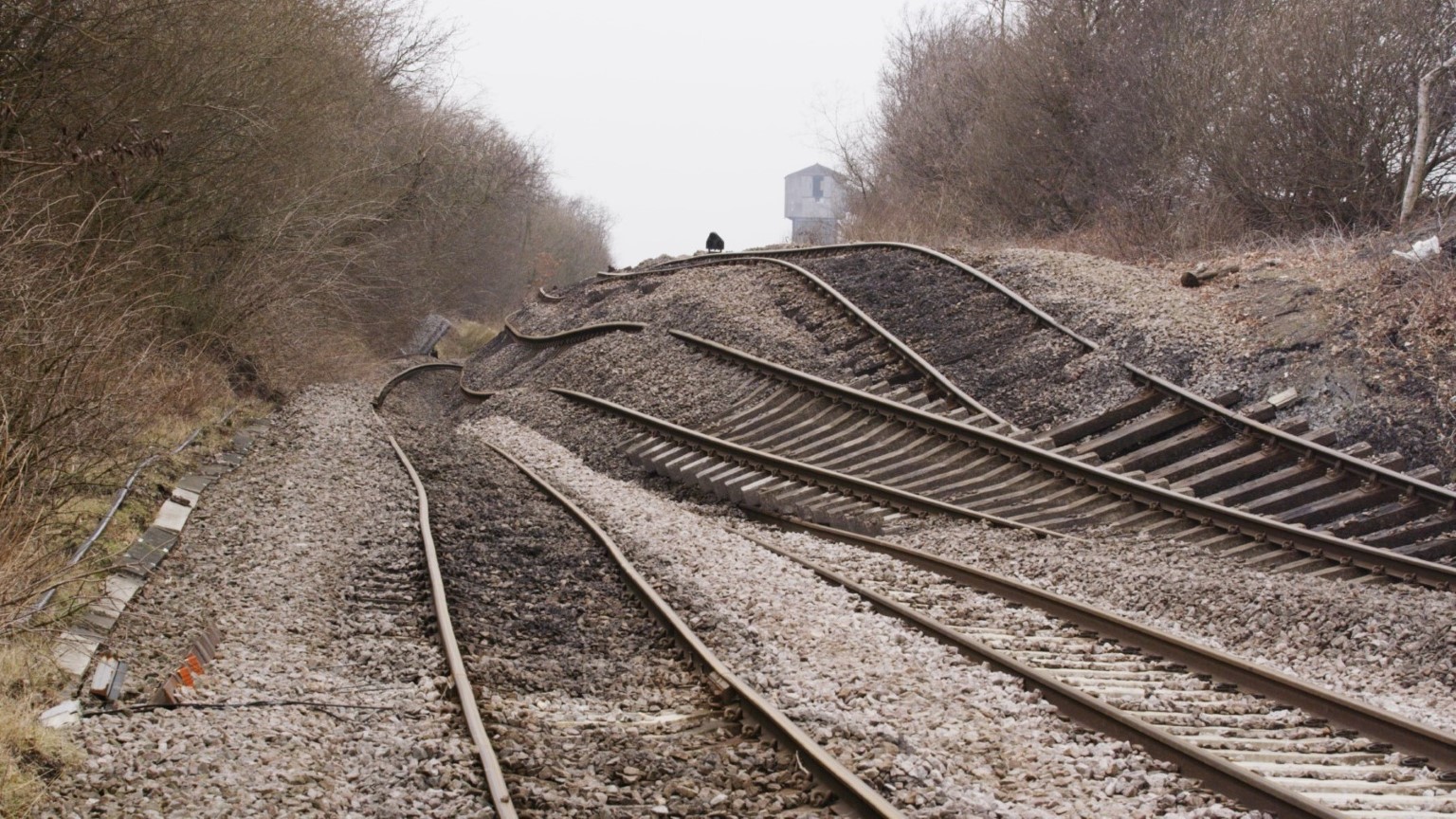 Huge rotational landslide which has caused the railway to move and distort. The railway tracks lie buckled and twisted. 
